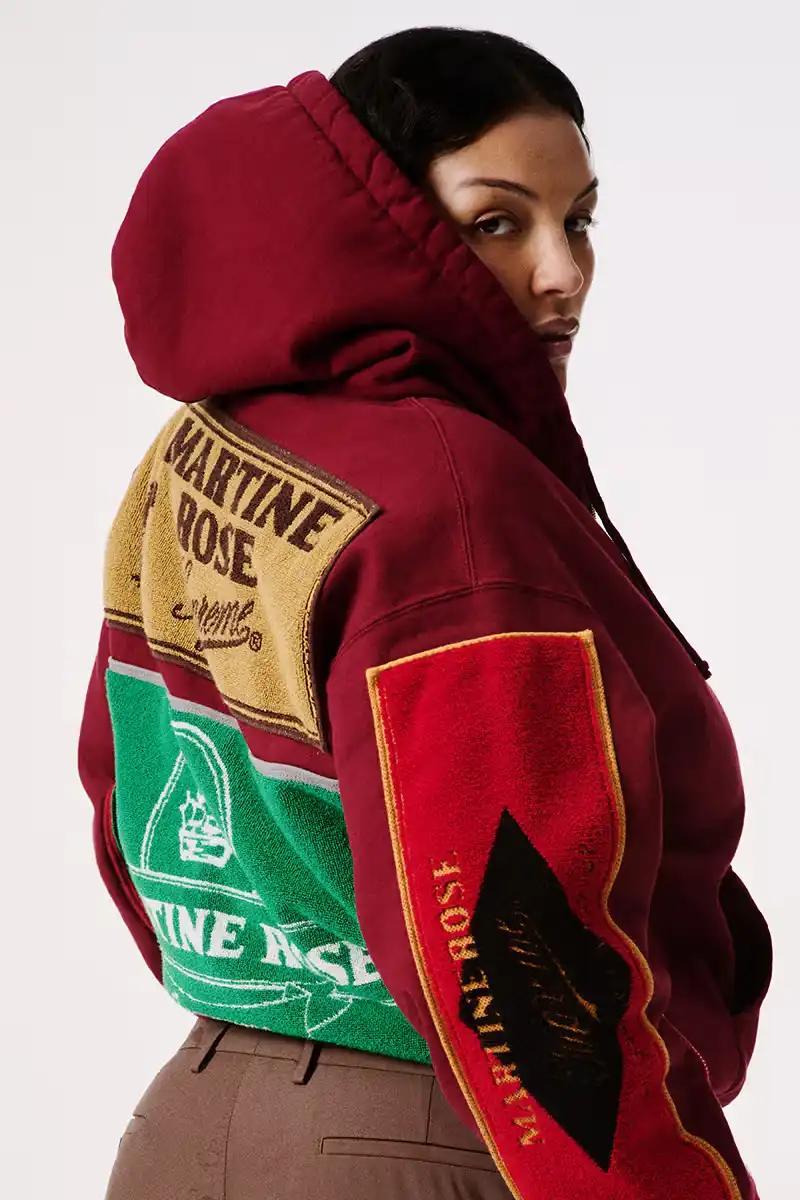 A variety of garments and accessories from the Martine Rose x Supreme capsule collection, including jackets, shirts, sweaters, hoodies, t-shirts, leather pants, jeans, bags, scarves, and hats