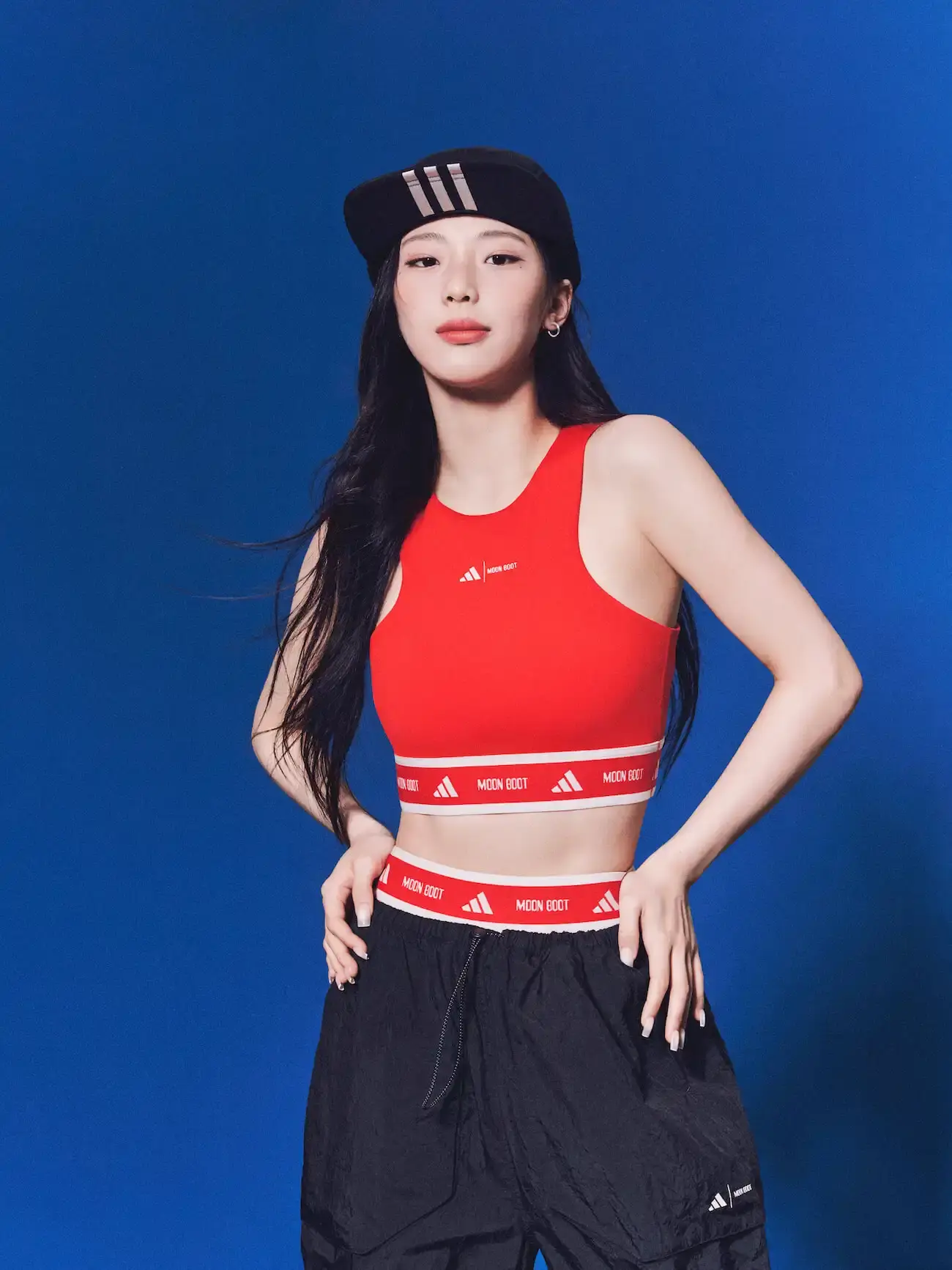 The image shows the collaborative collection between adidas Sportswear and Moon Boot. It includes various apparel and footwear items like snow boots, jackets, leggings, and accessories in a mix of sporty and fashionable designs.