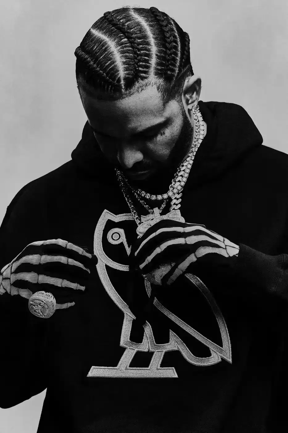 Drake and his OVO team members pose together wearing black hoodies with the OVO owl logo for the new "OG" campaign. The image shows Drake in the center, surrounded by his close associates including Jonny Roxx and Niko Carino. They stand against a plain background, emphasizing the group's unity and the branded clothing. Additional images feature individual shots of each team member modeling various pieces from the new OVO collection, including a letterman jacket and other sweater designs (image 4 of 7)