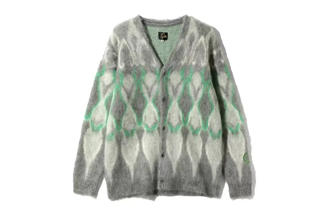HIDDEN.NY AND NEEDLES UNVEIL LATEST COLLAB CAPSULE HIDDEN.NY and NEEDLES streetwear collaboration capsule collection featuring green hues, overlapping logos, and digital-inspired graphics on classic NEEDLES styles like Cut t-shirts, tracksuits, and mohair cardigans. Exclusive launch at NEPENTHES Tokyo on September 27, including unique REBUILD BY NEEDLES pieces (image 9 of 15)