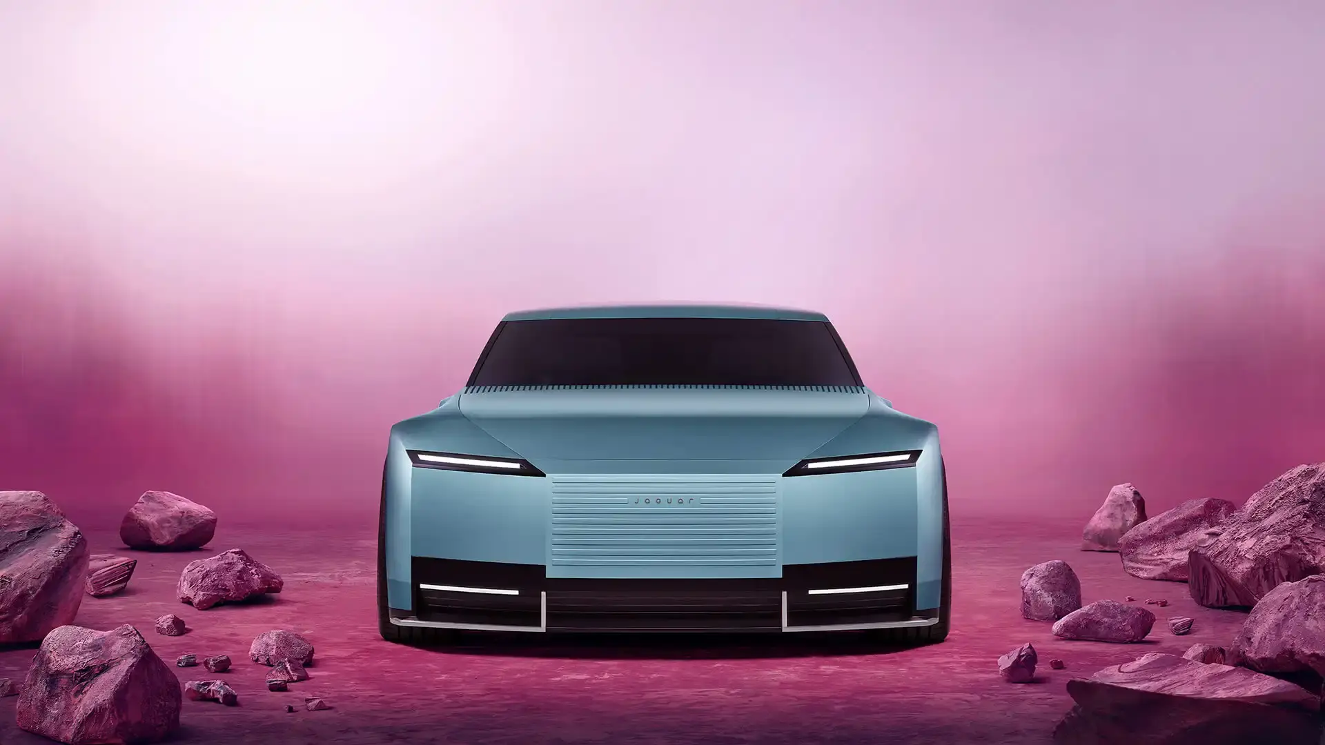 Jaguar Jaguar Type 00 concept car in Miami Pink, featuring an elongated electric vehicle design with butterfly doors, 23-inch alloy wheels, and a sleek, avant-garde silhouette against a minimalist background.