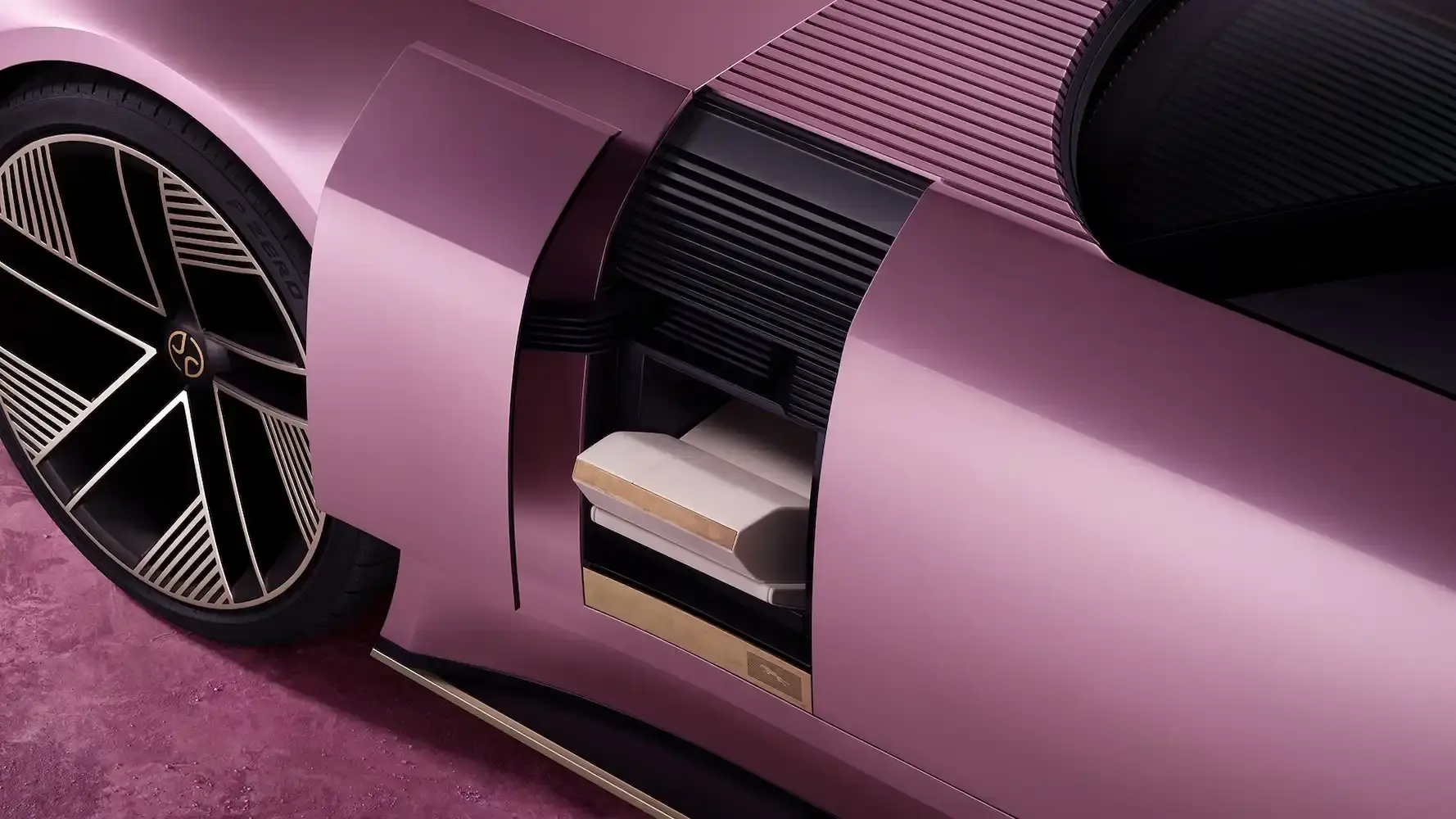 Jaguar Jaguar Type 00 concept car in Miami Pink, featuring an elongated electric vehicle design with butterfly doors, 23-inch alloy wheels, and a sleek, avant-garde silhouette against a minimalist background. (image 3 of 6)