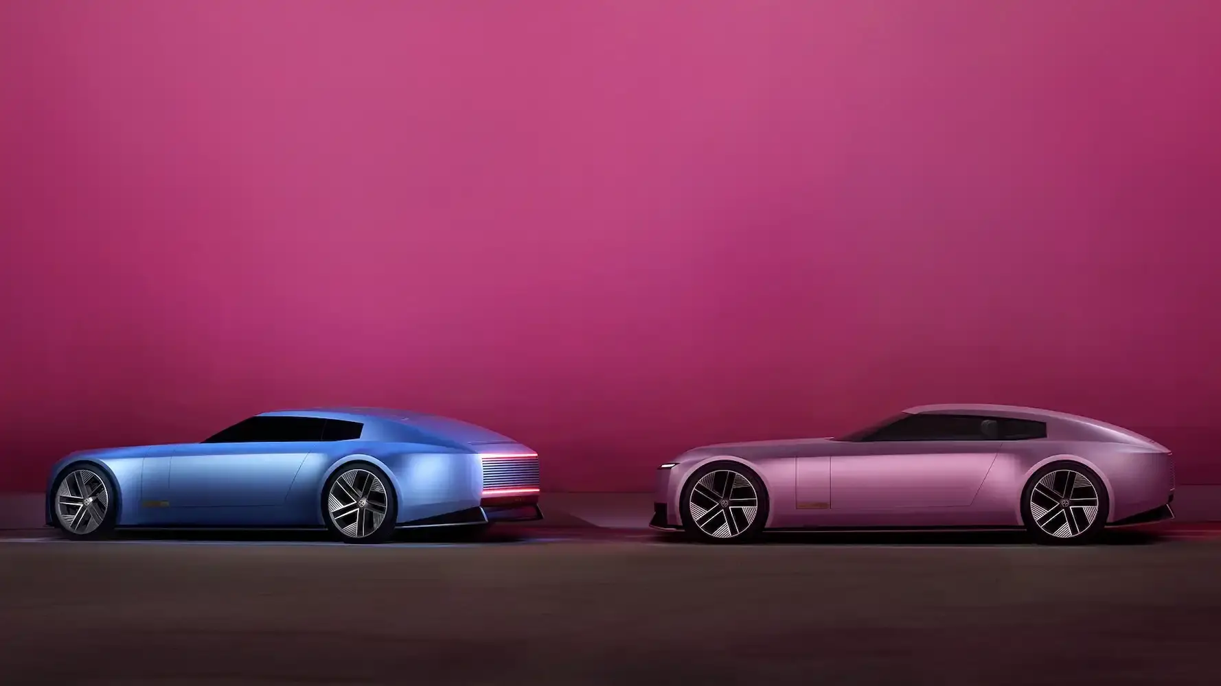 Jaguar Jaguar Type 00 concept car in Miami Pink, featuring an elongated electric vehicle design with butterfly doors, 23-inch alloy wheels, and a sleek, avant-garde silhouette against a minimalist background. (image 2 of 6)