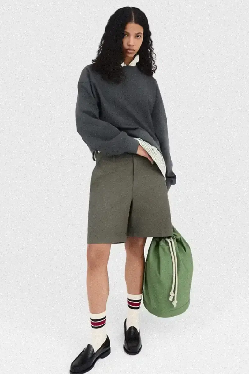 Uniqlo Models wearing Uniqlo x JW Anderson SS25 collection pieces, including blazers, button-ups, and casual wear in neutral tones against a white background (image 12 of 20)