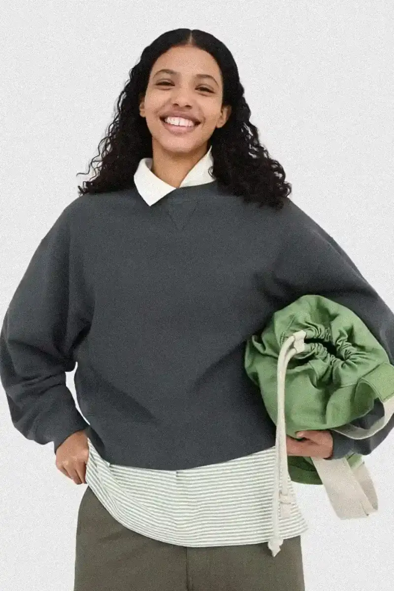 Uniqlo Models wearing Uniqlo x JW Anderson SS25 collection pieces, including blazers, button-ups, and casual wear in neutral tones against a white background (image 11 of 20)