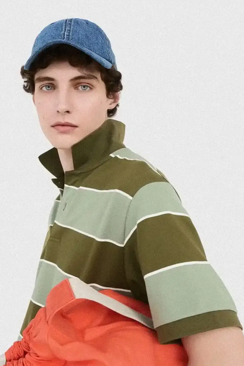 Uniqlo Models wearing Uniqlo x JW Anderson SS25 collection pieces, including blazers, button-ups, and casual wear in neutral tones against a white background (image 2 of 20)
