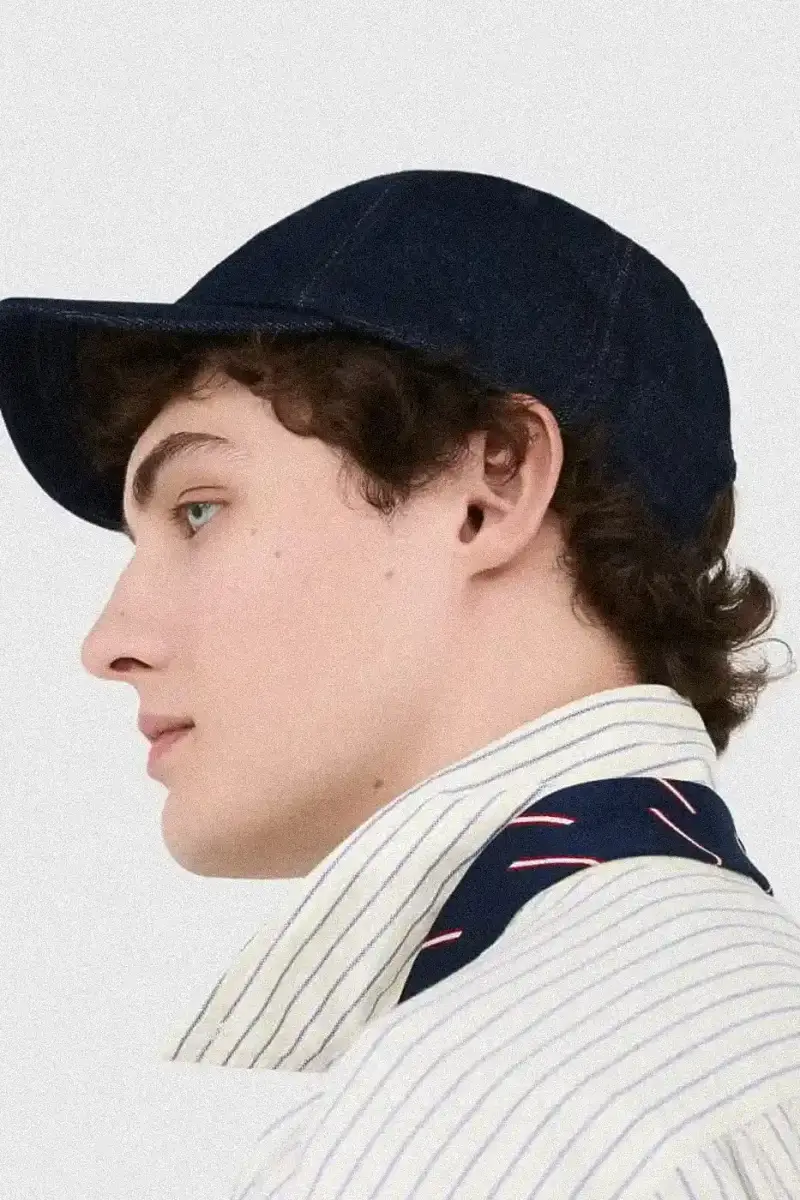 Uniqlo Models wearing Uniqlo x JW Anderson SS25 collection pieces, including blazers, button-ups, and casual wear in neutral tones against a white background (image 5 of 20)