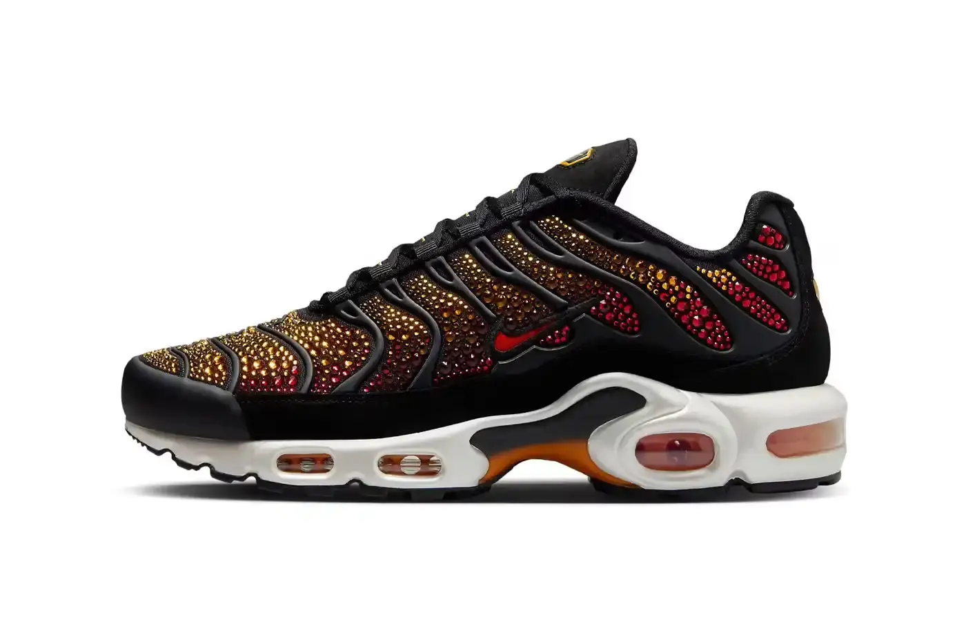 Nike Nike Air Max Plus sneaker in sunset gradient, embellished with sparkling Swarovski crystals on TPU overlays, showcasing a luxurious blend of athletic design and high-fashion craftsmanship.