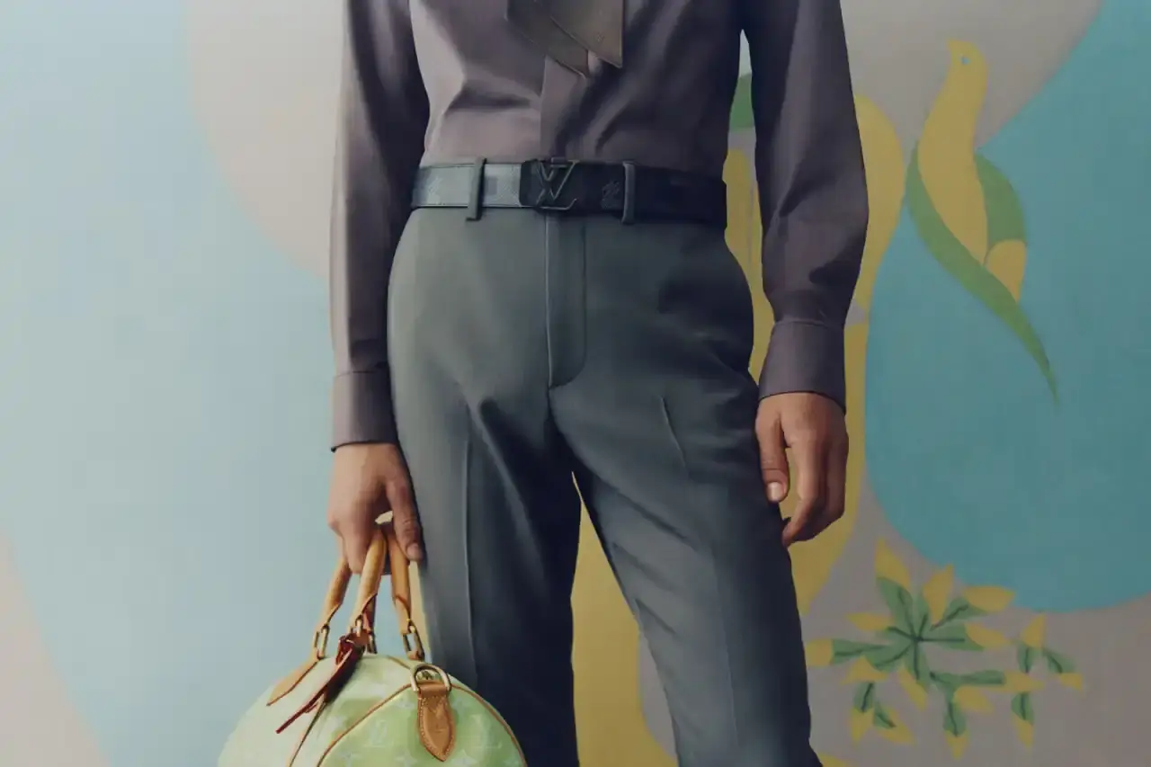 Stef Mitchell Models wearing Louis Vuitton Spring 2025 collection pose in UNESCO's headquarters. They're dressed in earth-toned suits and casual wear, photographed in formal meeting rooms and gardens. The images showcase bags, sunglasses, and diplomatic-inspired fashion against modernist architecture. (image 3 of 15)