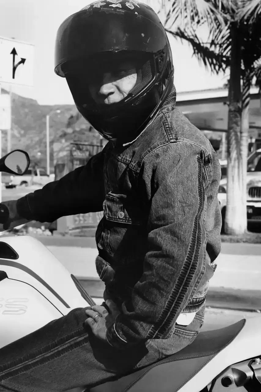 Levi's x UNDERCOVER Flea, bassist of Red Hot Chili Peppers, wearing a dark denim Levi's x UNDERCOVER Pinnacle Type II Trucker Jacket against a neutral background (image 2 of 15)