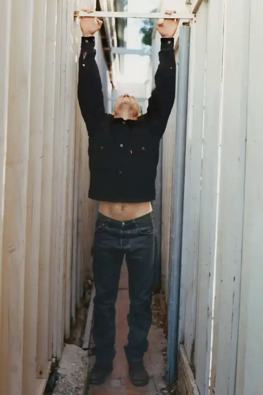 Levi's x UNDERCOVER Flea, bassist of Red Hot Chili Peppers, wearing a dark denim Levi's x UNDERCOVER Pinnacle Type II Trucker Jacket against a neutral background (image 14 of 15)