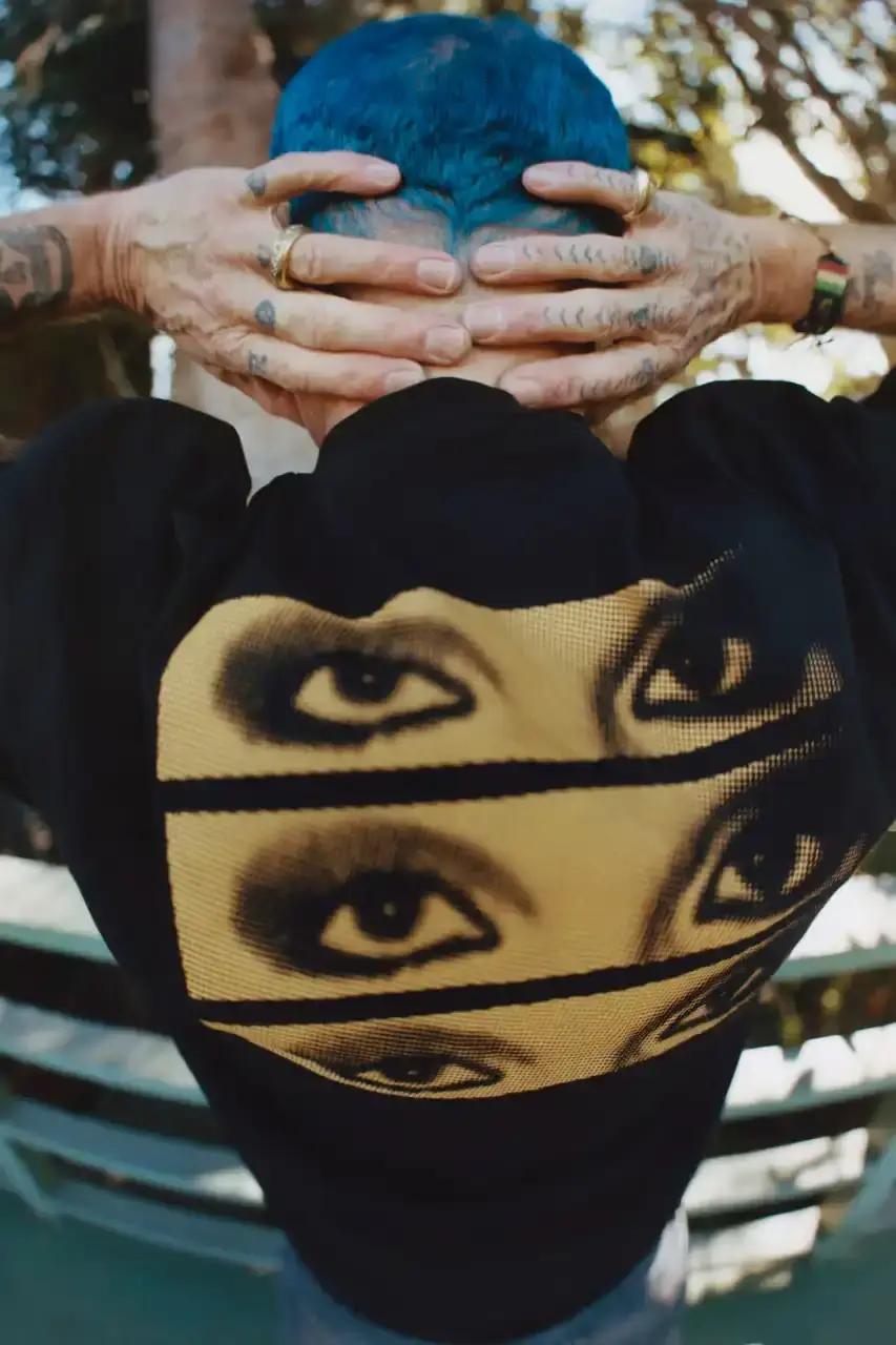 Levi's x UNDERCOVER Flea, bassist of Red Hot Chili Peppers, wearing a dark denim Levi's x UNDERCOVER Pinnacle Type II Trucker Jacket against a neutral background (image 3 of 15)