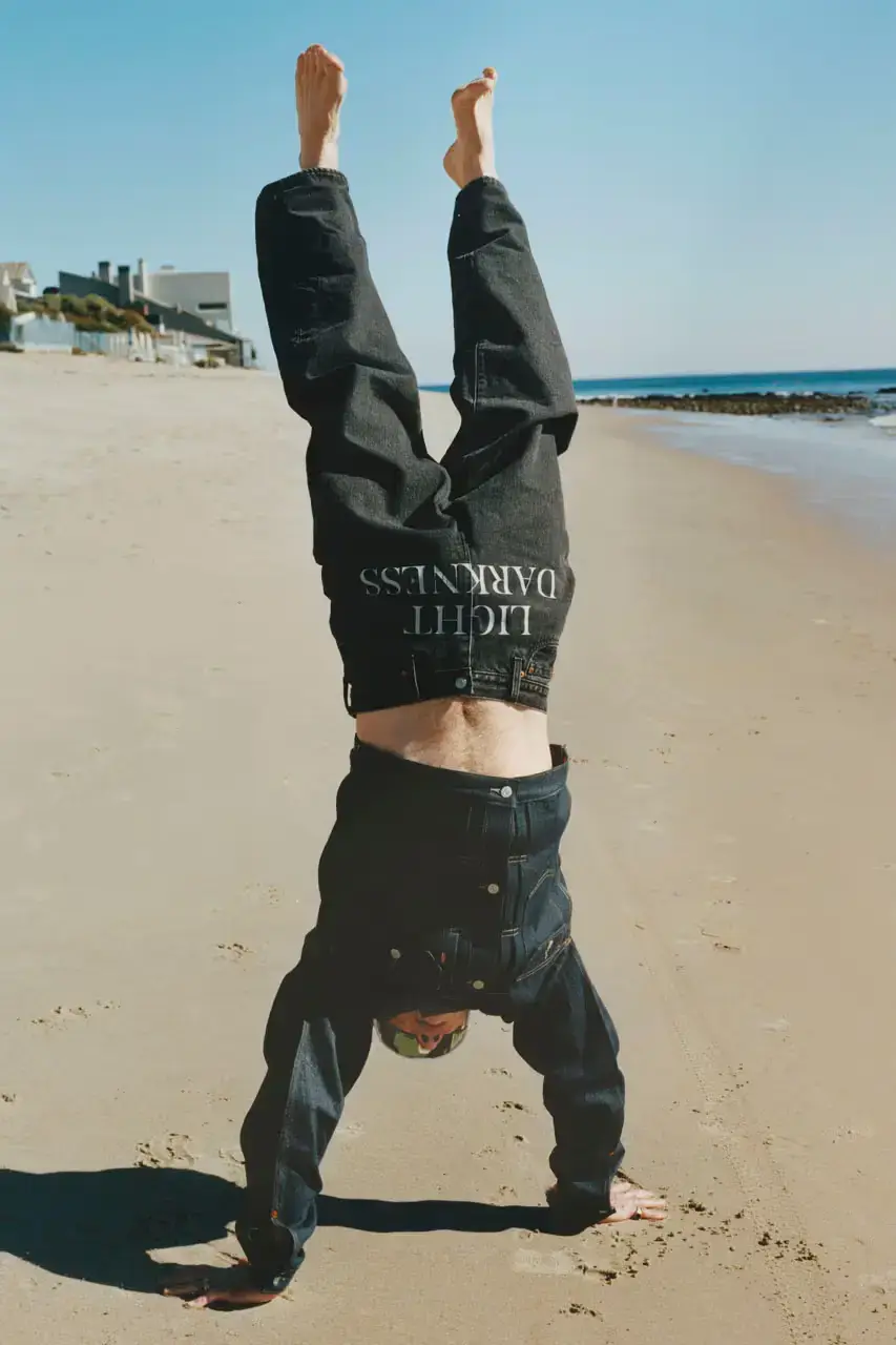 Levi's x UNDERCOVER Flea, bassist of Red Hot Chili Peppers, wearing a dark denim Levi's x UNDERCOVER Pinnacle Type II Trucker Jacket against a neutral background (image 7 of 15)