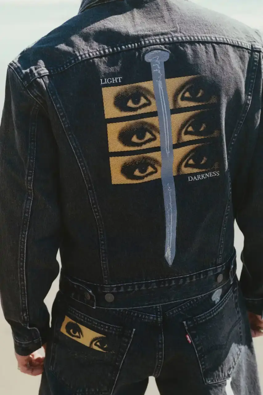 Levi's x UNDERCOVER Flea, bassist of Red Hot Chili Peppers, wearing a dark denim Levi's x UNDERCOVER Pinnacle Type II Trucker Jacket against a neutral background (image 12 of 15)