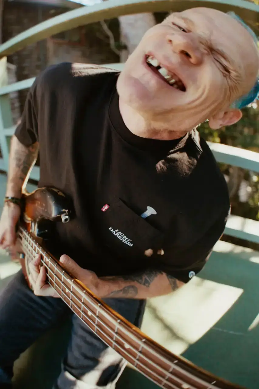 Levi's x UNDERCOVER Flea, bassist of Red Hot Chili Peppers, wearing a dark denim Levi's x UNDERCOVER Pinnacle Type II Trucker Jacket against a neutral background (image 9 of 15)