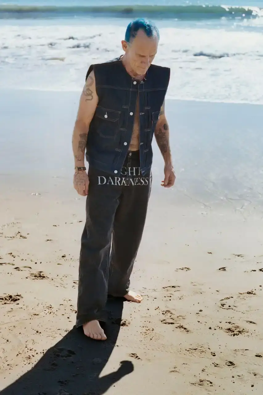 Levi's x UNDERCOVER Flea, bassist of Red Hot Chili Peppers, wearing a dark denim Levi's x UNDERCOVER Pinnacle Type II Trucker Jacket against a neutral background (image 8 of 15)