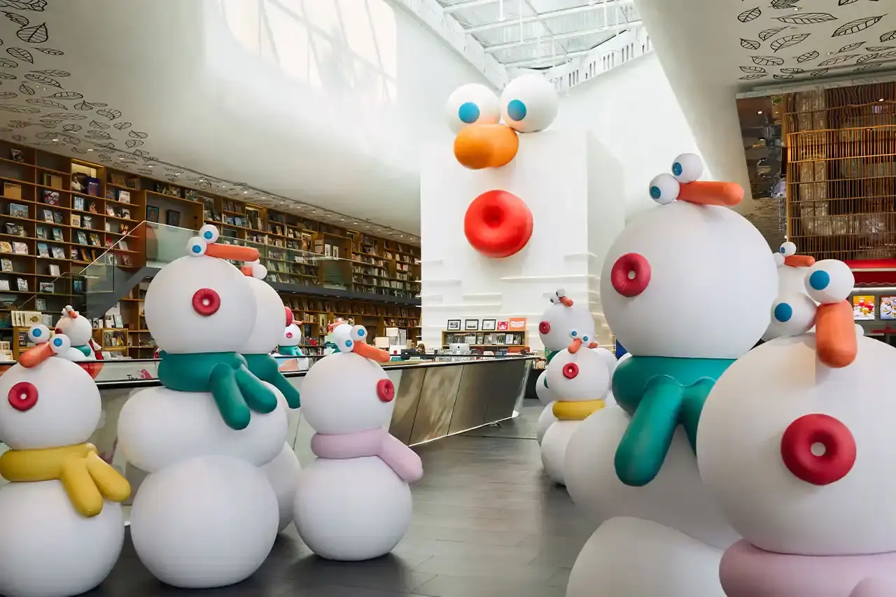 Central Embassy An array of white sculptural snowmen designed by Lucas Zanotto displayed throughout Central Embassy's modern interior, centered around a tall Christmas tree decorated in white and silver (image 4 of 6)
