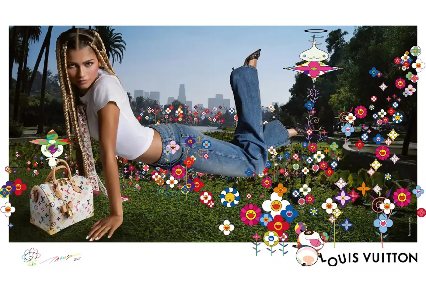 Louis Vuitton Zendaya poses in casual denim and a white crop top against a green screen background with Murakami's floral motifs. She wears a white Louis Vuitton x Murakami bandeau and holds a matching Keepall bag (image 3 of 5)